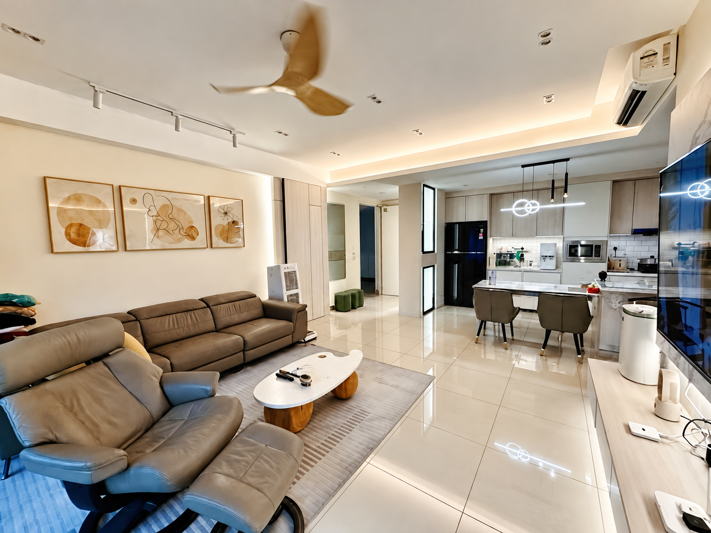 Open living room with sofa, dining area and fitted kitchen